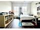 Bright and well-decorated bedroom featuring a cozy bed, dark wood floors, and a dedicated study corner with ample natural light at 1411 Wisteria Wall Dr, Suwanee, GA 30024