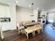 Bright dining area with a stylish light fixture and a stone fireplace feature at 1411 Wisteria Wall Dr, Suwanee, GA 30024