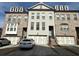 Charming townhome with brick elevation, two-car garage and neatly maintained landscaping at 1411 Wisteria Wall Dr, Suwanee, GA 30024