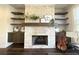 Living room showing the fireplace with stone surround and wood mantel at 1411 Wisteria Wall Dr, Suwanee, GA 30024