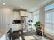 Well-lit kitchen with stainless steel refrigerator and modern appliances near bright windows at 1411 Wisteria Wall Dr, Suwanee, GA 30024