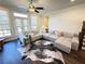 Bright living room featuring hardwood floors and a cozy sectional sofa at 1411 Wisteria Wall Dr, Suwanee, GA 30024
