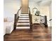 Elegant staircase with wood and white risers and decorative accents on the landing at 1411 Wisteria Wall Dr, Suwanee, GA 30024