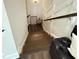 Dark wood staircase with landing featuring decor against paneled walls at 1411 Wisteria Wall Dr, Suwanee, GA 30024
