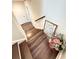 Hardwood staircase with landing featuring decor and a view to the doorway at 1411 Wisteria Wall Dr, Suwanee, GA 30024