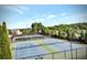 A great view of well-maintained community tennis courts with lush green surroundings on a clear day at 1411 Wisteria Wall Dr, Suwanee, GA 30024