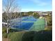 View of a well-maintained tennis court facility surrounded by trees, offering sports and recreation opportunities at 1411 Wisteria Wall Dr, Suwanee, GA 30024