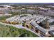 High aerial of a large townhome community surrounded by lush landscaping at 3180 Spicy Cedar Ln, Lithonia, GA 30038