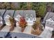 Aerial view of a charming townhome with a two-car garage and well-maintained landscaping during autumn at 3180 Spicy Cedar Ln, Lithonia, GA 30038