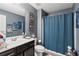 Modern bathroom featuring a vanity with storage, a toilet, and a shower with a stylish curtain at 3180 Spicy Cedar Ln, Lithonia, GA 30038