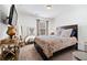 Cozy bedroom with natural light, featuring neutral decor, a queen-size bed, and stylish furnishings at 3180 Spicy Cedar Ln, Lithonia, GA 30038