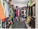 Walk-in closet with ample storage space, shelving, and a neutral-toned carpet at 3180 Spicy Cedar Ln, Lithonia, GA 30038