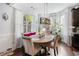Charming dining area with a rustic table, modern lighting, and large windows at 3180 Spicy Cedar Ln, Lithonia, GA 30038