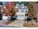Charming townhome with a two-car garage, brick facade, and well-maintained landscaping in a suburban neighborhood at 3180 Spicy Cedar Ln, Lithonia, GA 30038