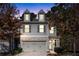Charming townhome featuring a two-car garage, neutral siding, and a welcoming front entrance at 3180 Spicy Cedar Ln, Lithonia, GA 30038
