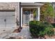 Inviting front entrance with a well-manicured bush and a charming wreath on the front door at 3180 Spicy Cedar Ln, Lithonia, GA 30038