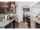 Well-lit kitchen featuring stainless steel appliances and dark cabinetry with granite countertops and stylish backsplash at 3180 Spicy Cedar Ln, Lithonia, GA 30038