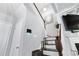 Bright staircase with dark wood steps, white walls, and a modern lighting fixture at 3180 Spicy Cedar Ln, Lithonia, GA 30038