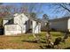 Wide shot of the backyard with a cozy seating area, lush grass, and the home's exterior at 731 Hobart Se Ave, Atlanta, GA 30312