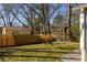 Spacious backyard with a grassy lawn, seating area, privacy fence, and charming outbuildings at 731 Hobart Se Ave, Atlanta, GA 30312
