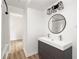 Modern bathroom featuring a double sink vanity, round mirror, and sleek lighting fixtures at 731 Hobart Se Ave, Atlanta, GA 30312
