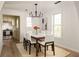 Bright dining room open to the kitchen featuring a large table and windows at 731 Hobart Se Ave, Atlanta, GA 30312