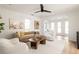 Bright living room features neutral furniture, an area rug, and a ceiling fan at 731 Hobart Se Ave, Atlanta, GA 30312