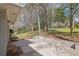 Back patio of home, showing an outdoor living space with brick accents and a view of the large, grassy backyard at 3532 Dial Dr, Stone Mountain, GA 30083