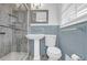 Bathroom featuring glass shower, tile walls, and white pedestal sink at 3532 Dial Dr, Stone Mountain, GA 30083