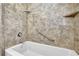 Relax in this bathroom, featuring a tub with safety bars and stone-look walls at 3532 Dial Dr, Stone Mountain, GA 30083