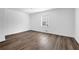 Bright, airy bedroom featuring hardwood floors and a large window with neighborhood views at 3532 Dial Dr, Stone Mountain, GA 30083