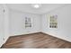 Bright bedroom with wood flooring, white walls, and two large windows at 3532 Dial Dr, Stone Mountain, GA 30083