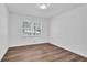 Bright bedroom with wood flooring, white walls, and a large window overlooking the yard at 3532 Dial Dr, Stone Mountain, GA 30083