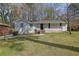 Traditional-style home with brick facade, offering a welcoming front yard with mature tree at 3532 Dial Dr, Stone Mountain, GA 30083