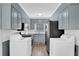 Kitchen with grey cabinets, stainless steel appliances, and washer/dryer hookups at 3532 Dial Dr, Stone Mountain, GA 30083