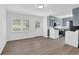 Open-concept kitchen featuring sleek gray cabinets, modern appliances, and wood flooring at 3532 Dial Dr, Stone Mountain, GA 30083