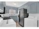 Kitchen with grey cabinets, stainless steel appliances, and washer/dryer hookups at 3532 Dial Dr, Stone Mountain, GA 30083