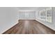 Bright, empty living room showcasing hardwood floors and large windows with tree views at 3532 Dial Dr, Stone Mountain, GA 30083