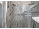 Close-up of a modern bathroom shower with marble walls and silver fixtures at 3532 Dial Dr, Stone Mountain, GA 30083