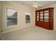 Bedroom featuring built in wood shelving, ceiling fan and carpeted floor at 6195 Mountainwell Dr, Roswell, GA 30075