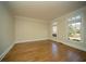 Cozy bedroom with hardwood floors, crown molding, and natural light from the windows at 6195 Mountainwell Dr, Roswell, GA 30075