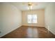 Bedroom with wood flooring and a ceiling fan and window providing natural light at 6195 Mountainwell Dr, Roswell, GA 30075