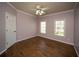 Bedroom with wood flooring and two windows providing natural light at 6195 Mountainwell Dr, Roswell, GA 30075