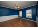Bedroom with wood flooring and windows providing natural light at 6195 Mountainwell Dr, Roswell, GA 30075