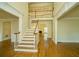 Bright foyer featuring hardwood floors, staircase, and an upper-level balcony at 6195 Mountainwell Dr, Roswell, GA 30075