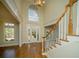 Grand foyer with a staircase, hardwood floors, high ceilings, and an abundance of natural light at 6195 Mountainwell Dr, Roswell, GA 30075