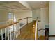 Hallway with hardwood flooring and views of the staircase and chandelier at 6195 Mountainwell Dr, Roswell, GA 30075