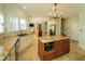 Large kitchen with a wooden island, granite counters, stainless appliances, and adjacent eating area at 6195 Mountainwell Dr, Roswell, GA 30075