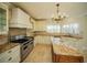 Well-equipped kitchen featuring a large island, stainless steel appliances, and ample cabinet storage at 6195 Mountainwell Dr, Roswell, GA 30075