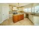 Bright eat-in kitchen features a center island, tiled floor and backsplash, and stainless steel appliances at 6195 Mountainwell Dr, Roswell, GA 30075
